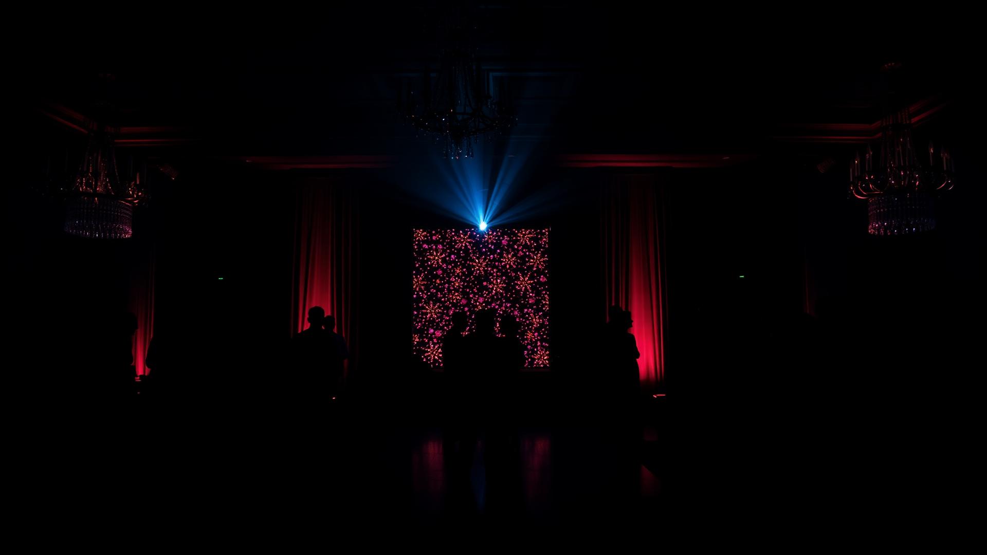 Illuminated custom backdrop installation at an evening event